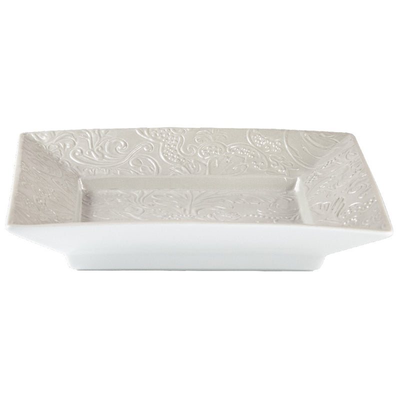 Square porcelain dish with embossed design on a white background