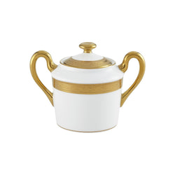 White sugar bowl with gold accents on a white background