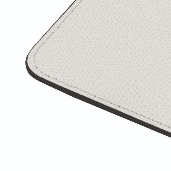 Close-up of Tao square rounded coaster in dust grey by Giobagnara, double-faced Italian leather