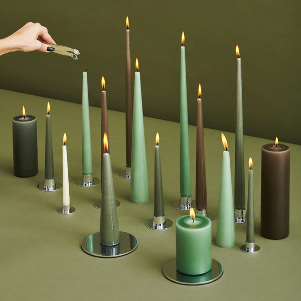 brown and green collection of lit taper candles 