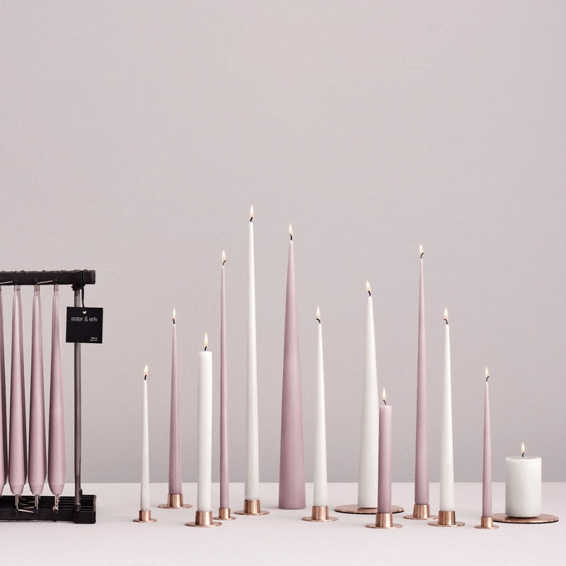 Set of pink and white candles on a gray background