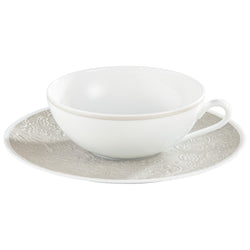 Italian Renaissance Irisé Pearl Grey tea cup and saucer by Raynaud in Limoges porcelain with engraved arabesques and pearl grey iridescence.