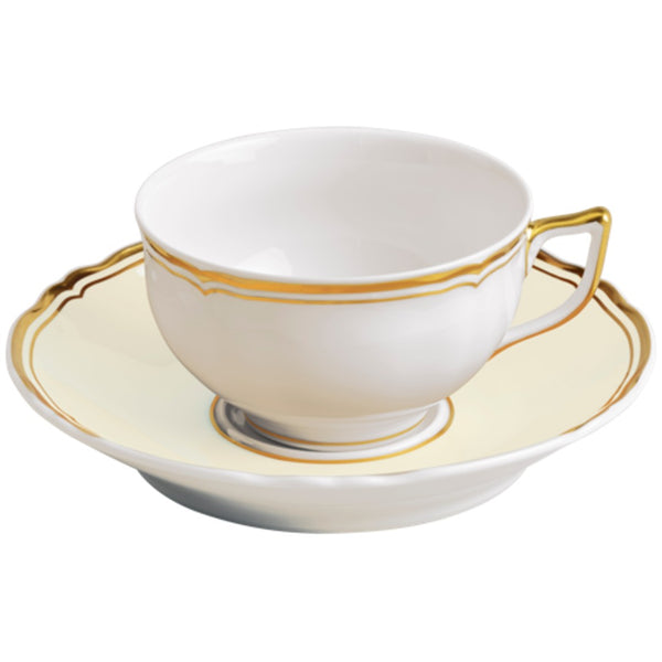 A white and gold porcelain tea cup with a cup and saucer, featuring floral patterns and gold accents.