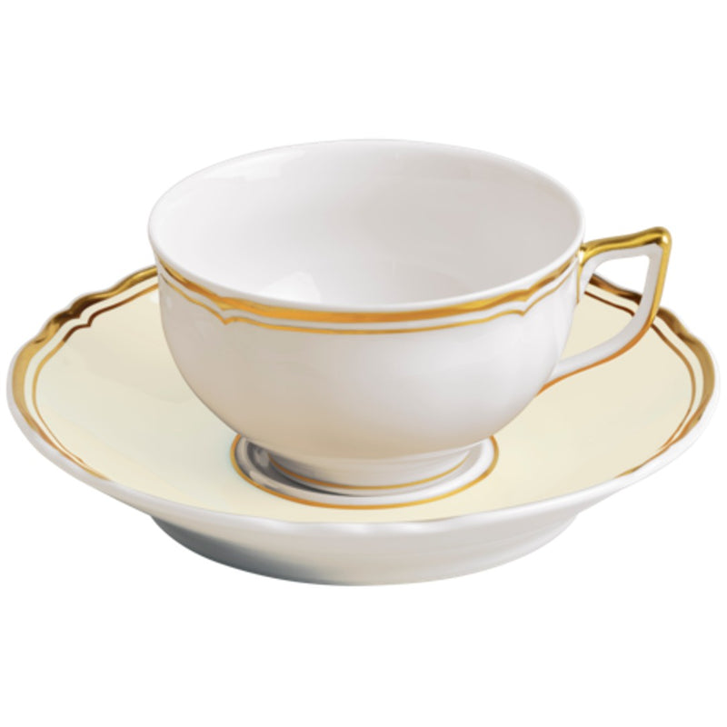 A white and gold porcelain tea cup with a cup and saucer, featuring floral patterns and gold accents.