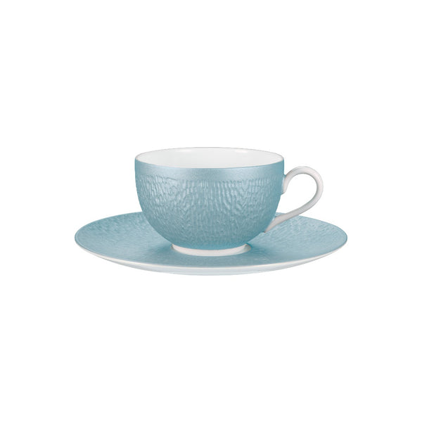 Light blue textured teacup and saucer set on a white background