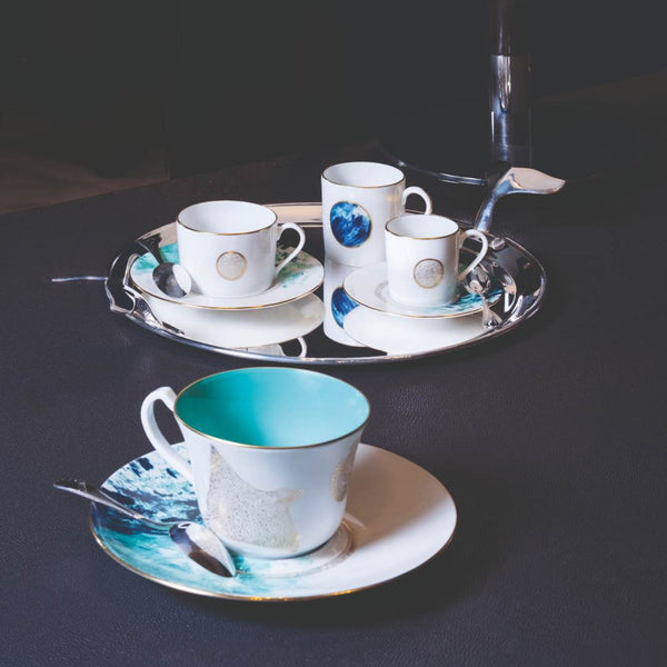Styled Haviland Océan Bleu Tea Cup and Saucer in Limoges porcelain with ocean blue and gold detailing.