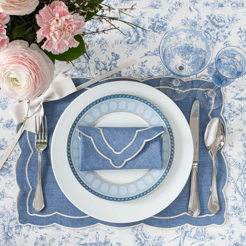 Toile de Jouy cotton tablecloth in blue with French scenic design by Roseberry Home styled with placemats and plates