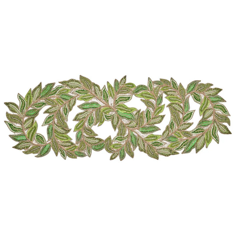 A decorative table runner featuring a trellis pattern with green and gold colors, with leaf-shaped glass and plastic beads and gold rhinestone accents.