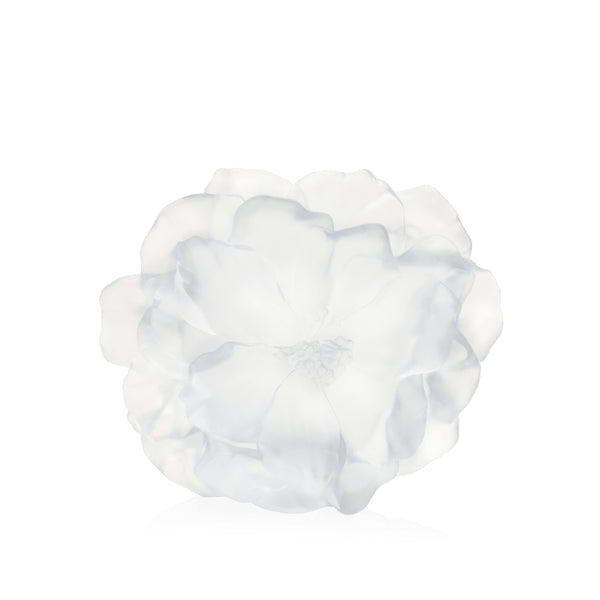 A white crystal vase with a floral design, resembling a camellia flower, on a plain background.