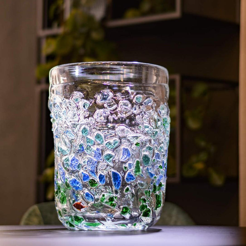 Glass vase with mosaic design on a blurred background