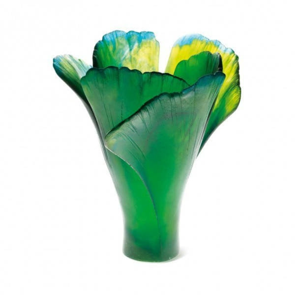 Glass vase with green and yellow leaf-like design on a white background