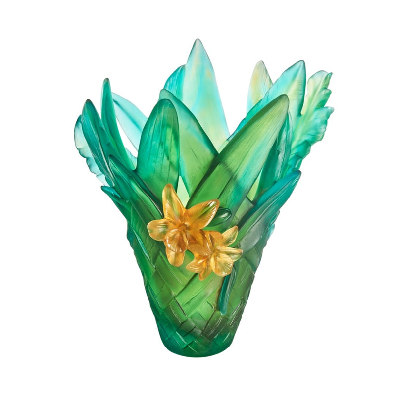 Decorative glass vase with green and blue design and yellow flowers on a white background