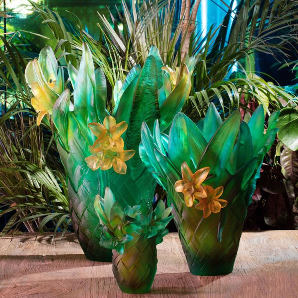 Decorative vases with leaf and flower design on a wooden surface