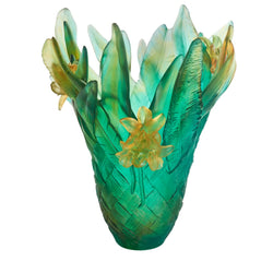 Decorative glass vase with green and yellow floral design on a white background