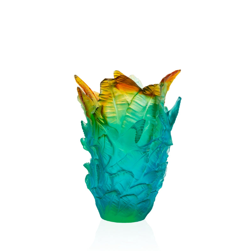 A tropical ombre crystal vase with vibrant blue, yellow, and green hues, handmade by Daum.