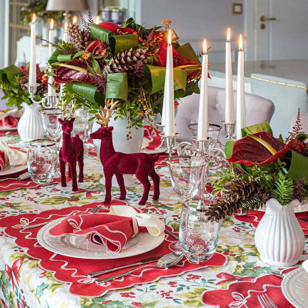 Festive table decorated with red velvet decor and candles
