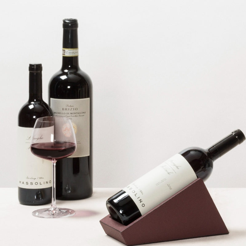 Wine bottles with a glass of red wine on a white background