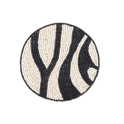 Zebra striped beaded drink coaster by Joanna Buchanan, bold black table decor

