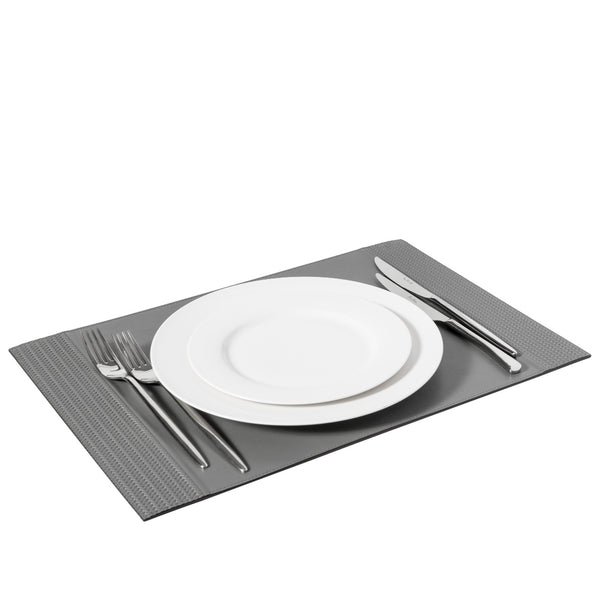 Grey rectangular leather placemat with woven side bands with white plate.