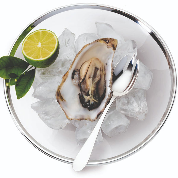Elegant oyster fork with wide prongs from Avantgarde collection in oyster bowl.