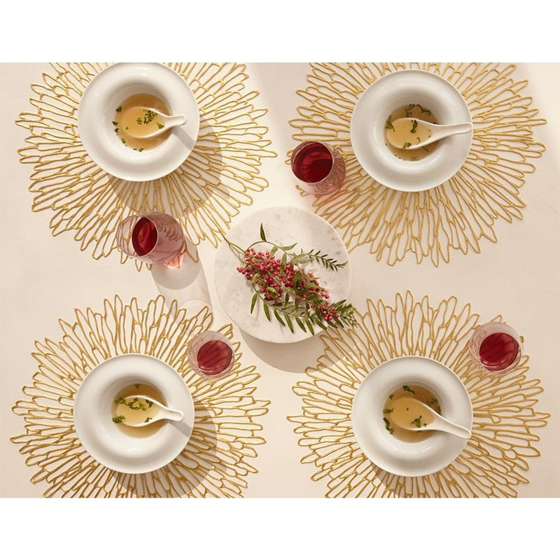 Gold Bloom round placemat with chrysanthemum openwork by Chilewich on luxury table ssetting.