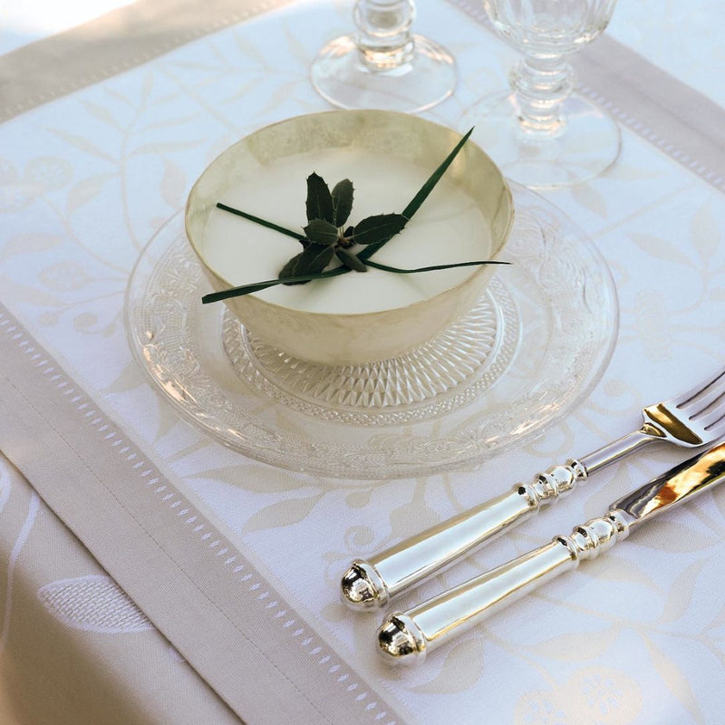 Venezia cotton napkin with subtle pattern and classic silhouette, styled for an elegant table setting.