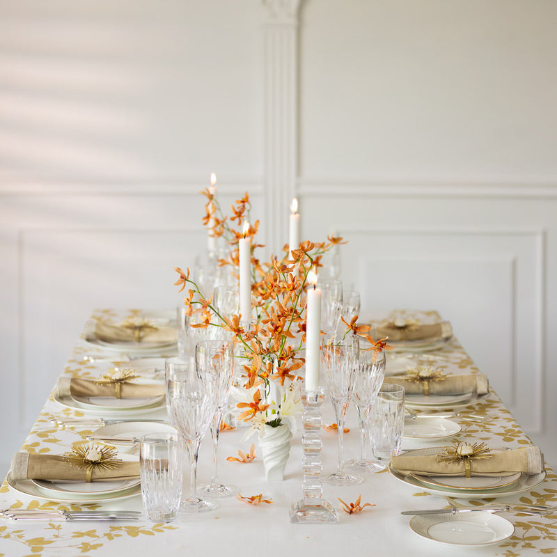a table with a white tablecloth and orange flowers