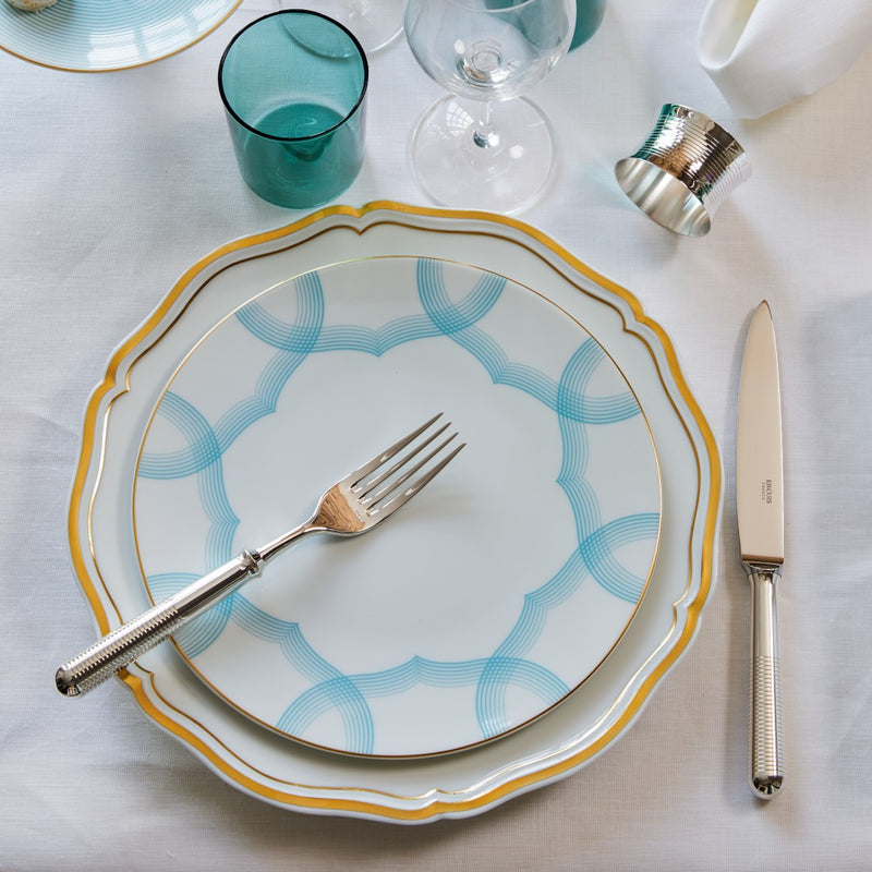 Transat silver-plated napkin ring by Ercuis, shown next to a plate.