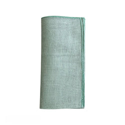 Garza linen gauze napkin in sage green folded on a white background, sold at Amiramour.
