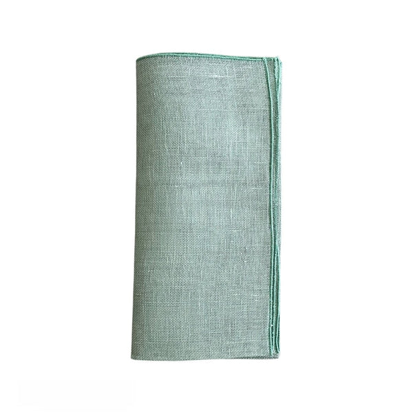 Garza linen gauze napkin in sage green folded on a white background, sold at Amiramour.