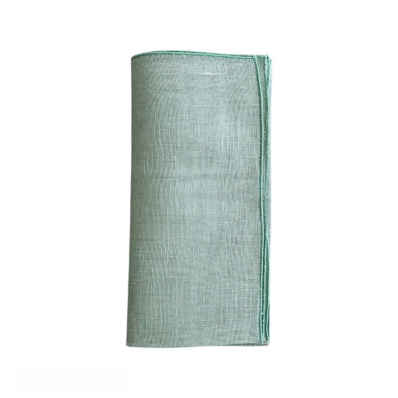 Garza linen gauze napkin in sage green folded on a white background, sold at Amiramour.
