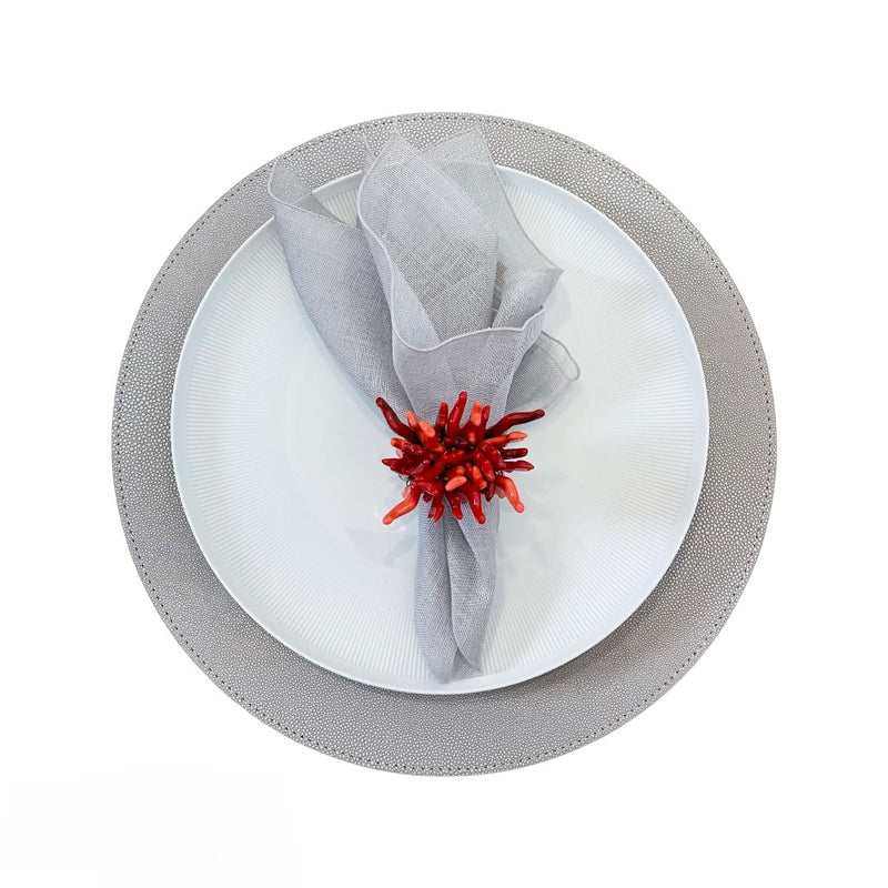 Garza napkin in grey styled on grey placemat with coral napkin ring, top view sold by Amiramour 