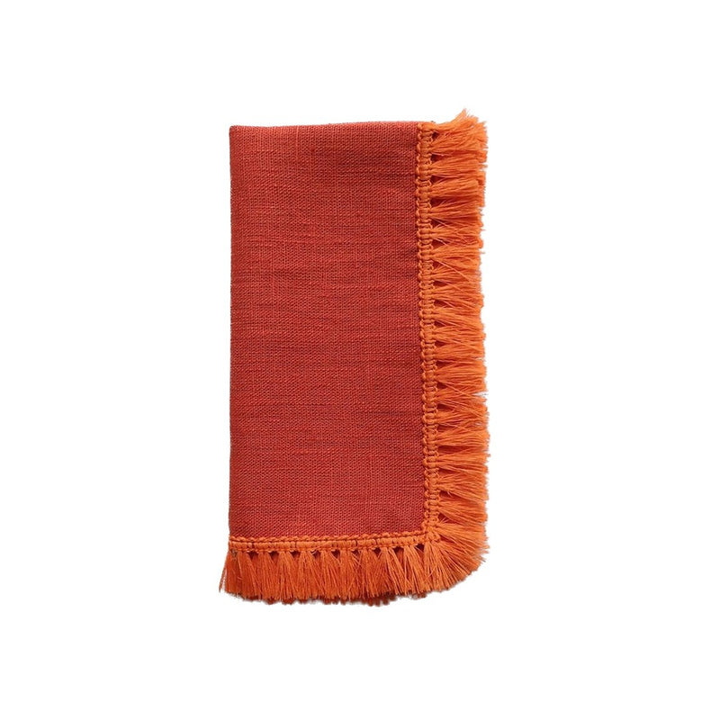 Orange linen napkin with fringe folded on white background, sold at Amiramour.
