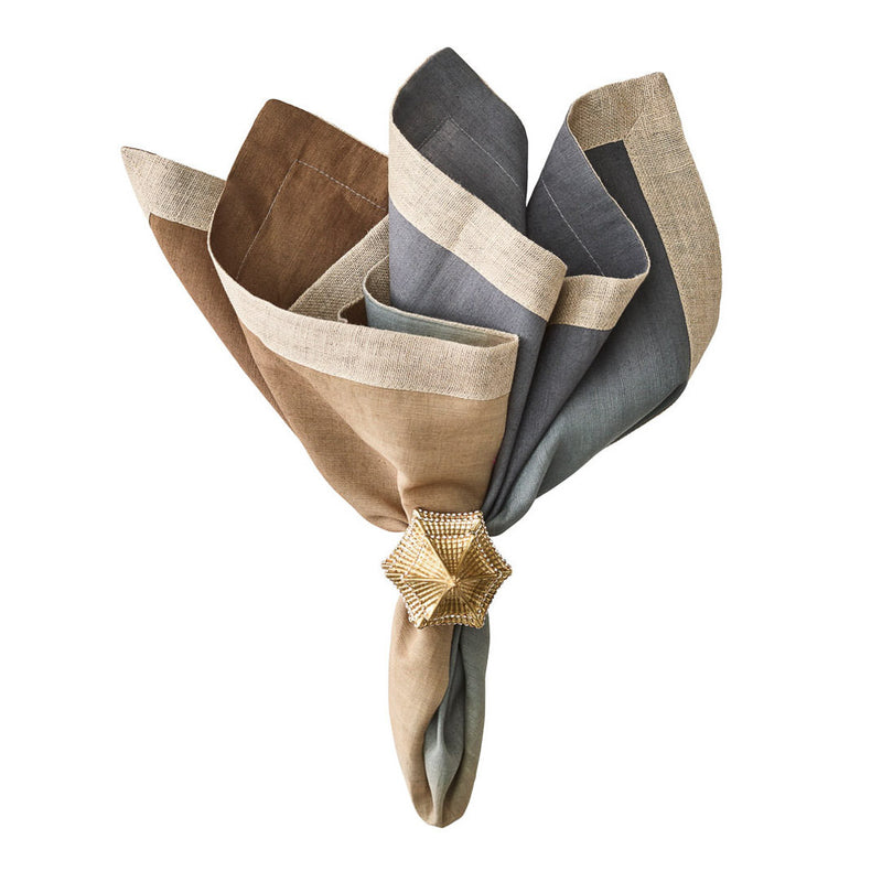 Beige, taupe, and grey linen napkin with metallic foil detail styled with gold napkin ring.
