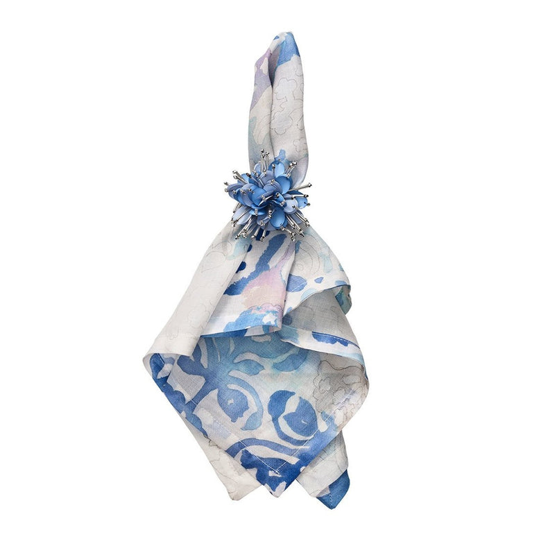 Styled watercolour napkin by Kim Seybert with periwinkle napkin ring on white background, sold at Amiramour.