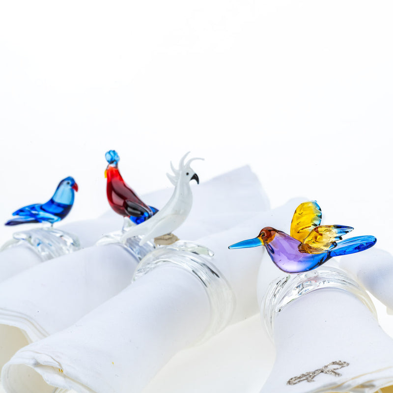 Handcrafted tropical birds napkin rings by Casa Rialto styled on white napkins close-up colibri bird.