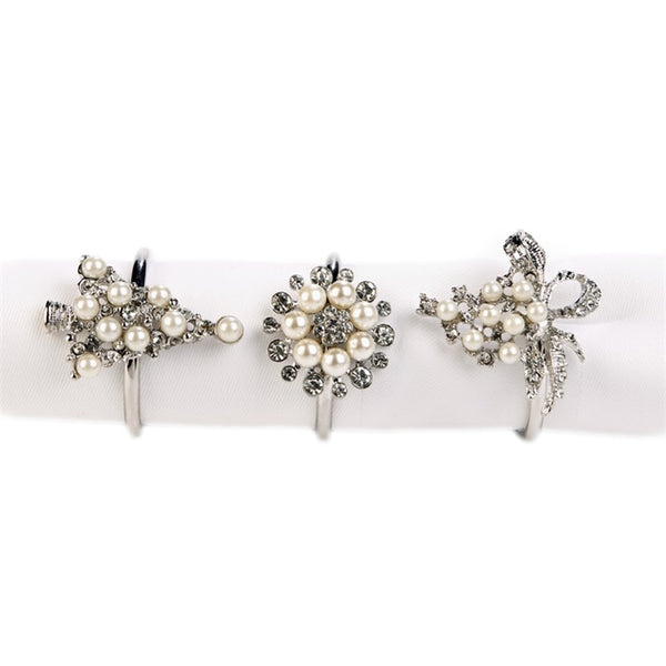 Set of 3 different Christmas napkin rings by Goodwill, on white backgound.