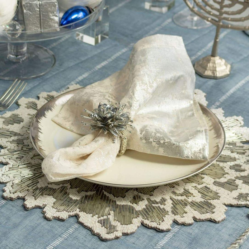 Sophisticated cream and silver table setting featuring Starburst napkin rings by Kim Seybert