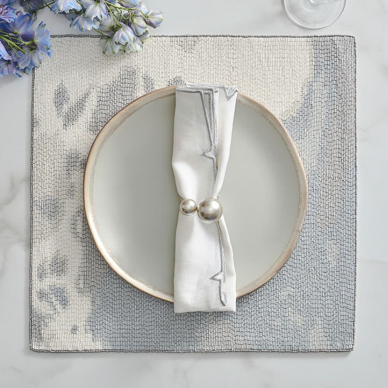 Light grey table setting featuring ivory and gold pearl napkin ring, available at Amiramour