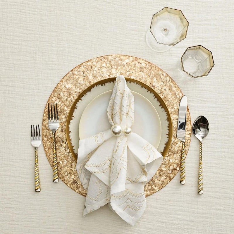 Golden-themed table arrangement with pearl napkin ring in soft ivory, sold by Amiramour
