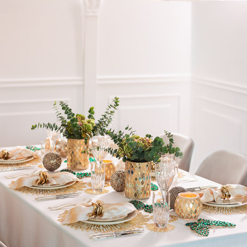 Wide shot of complete warm-toned table setting with Kim Seybert’s Flux Napkin Ring in Gold