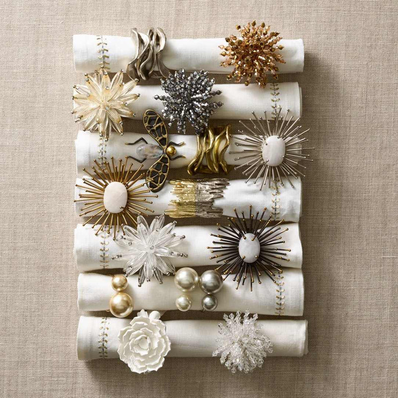 Group of assorted napkin rings including Kim Seybert’s Flux Napkin Ring in Gold