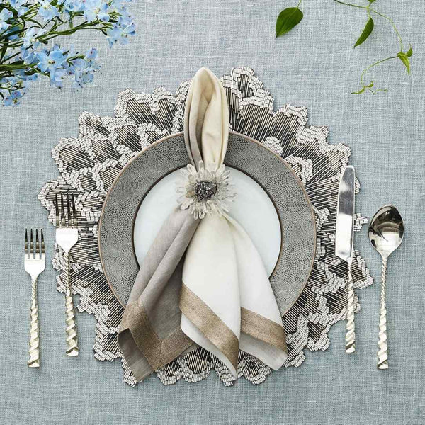 Bloom napkin ring styled on a napkin with clear quartz petals and silver center