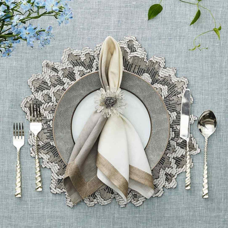 Bloom napkin ring styled on a napkin with clear quartz petals and silver center