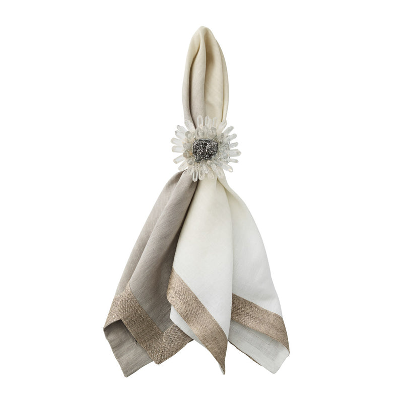 Elegant Bloom napkin ring in clear quartz and silver atop a folded napkin