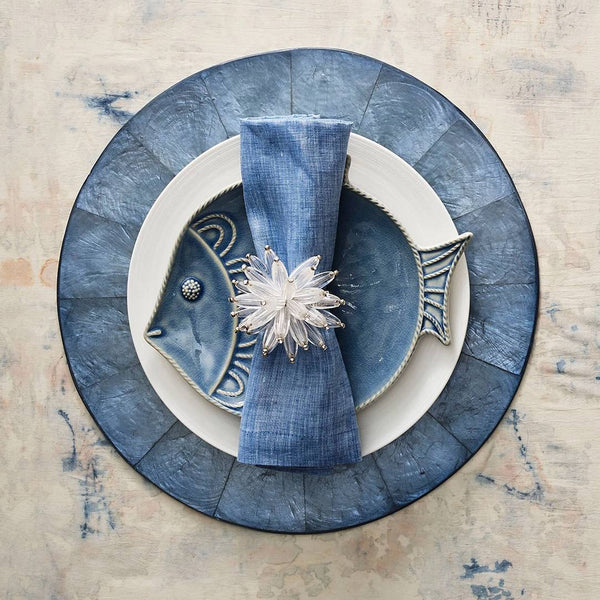 Elegant place setting with marine-blue tones featuring Constellation napkin ring by Kim Seybert