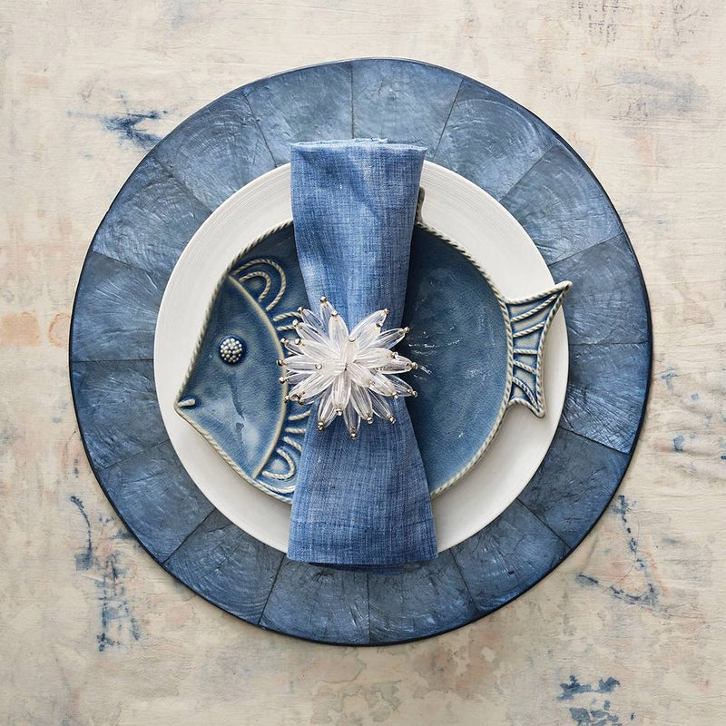 Elegant place setting with marine-blue tones featuring Constellation napkin ring by Kim Seybert