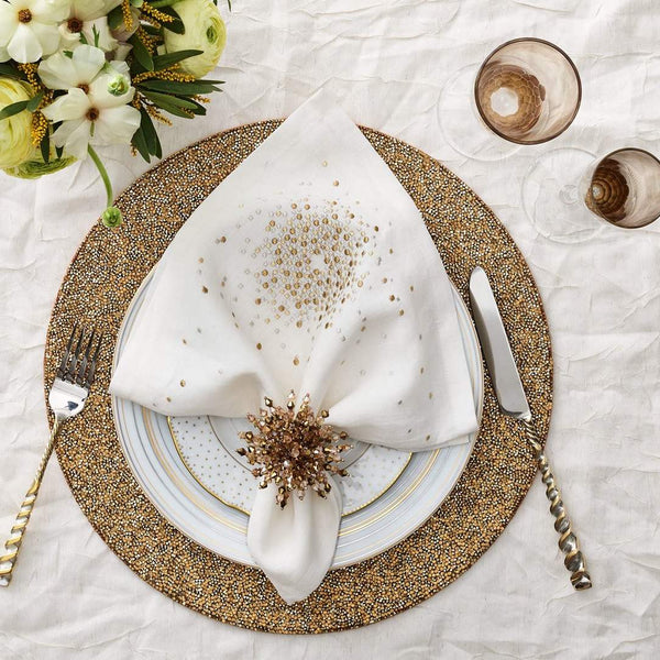 Gold and bronze holiday table décor featuring Brilliant Napkin Ring by Kim Seybert