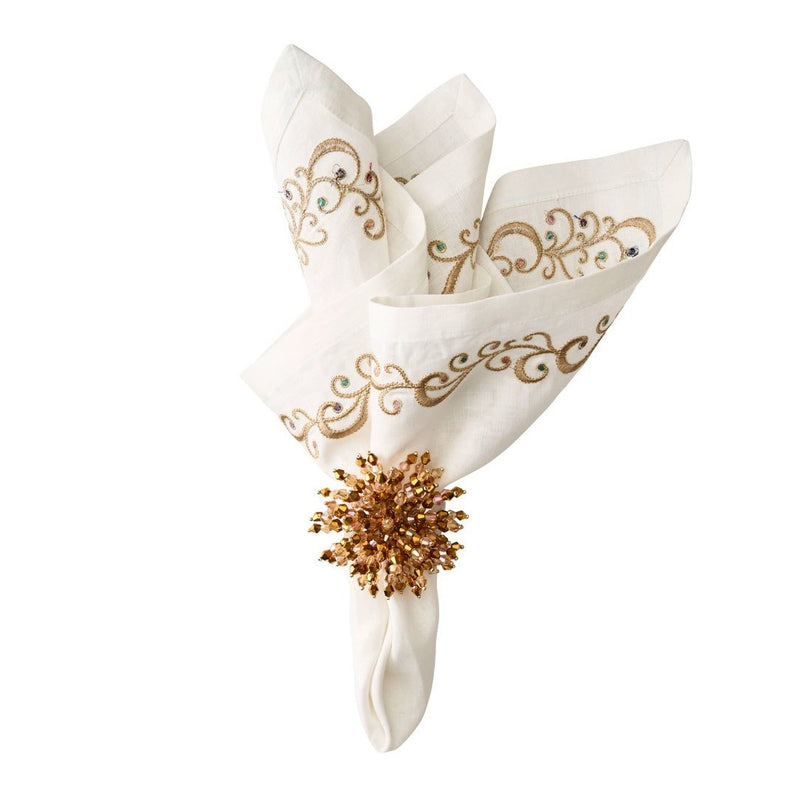 Brilliant Napkin Ring in gold styled on a neutral napkin by Kim Seybert