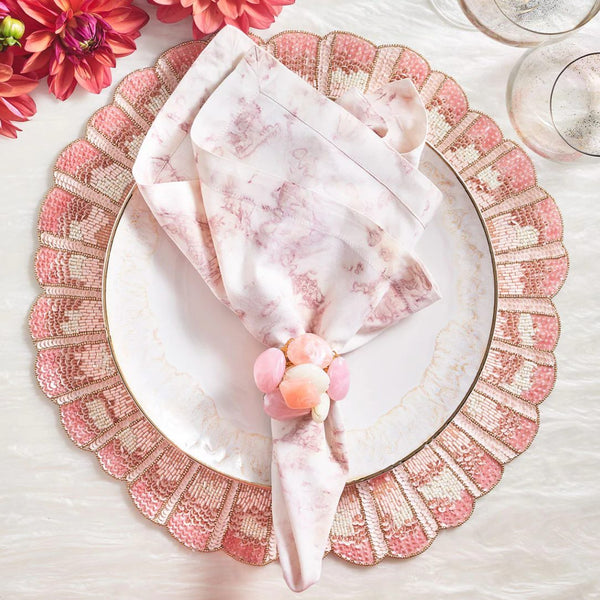 Blush Sea Stone Napkin Ring by Kim Seybert styled in a pastel pink and white table setting with elegant, airy décor